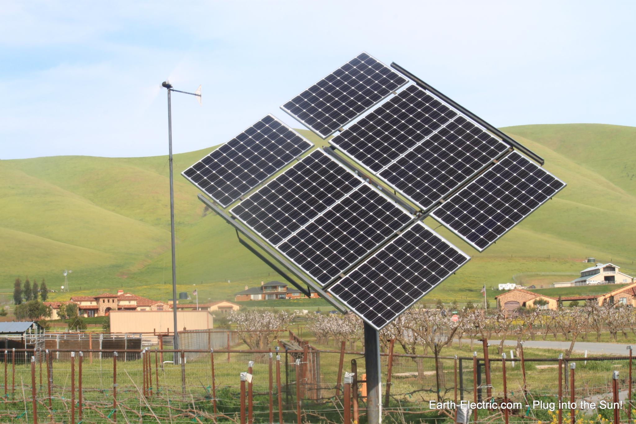 A windmill and her ground-mounted solar sister! What if everyone had such energy-makers? Would we need to rely on fossil fuels anymore? -2013, Hollister, CA.  Suniva solar panels. Schneider Electric inverter.