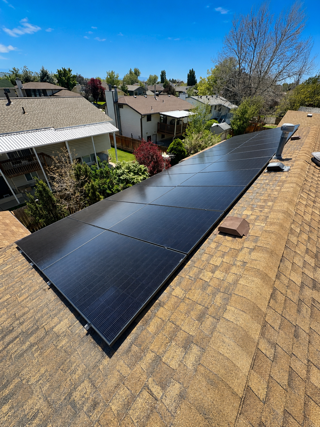 Flat-roof solar array with scenic mountain backdrop